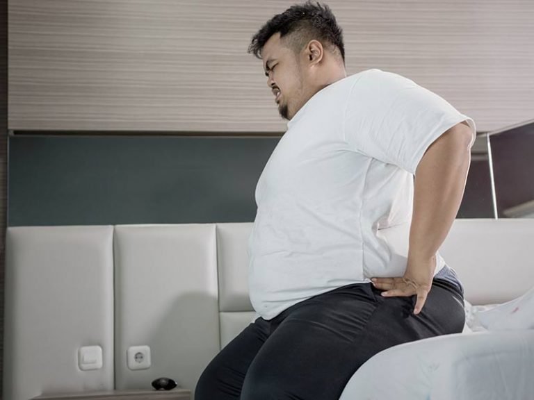 Man overweight with back pain