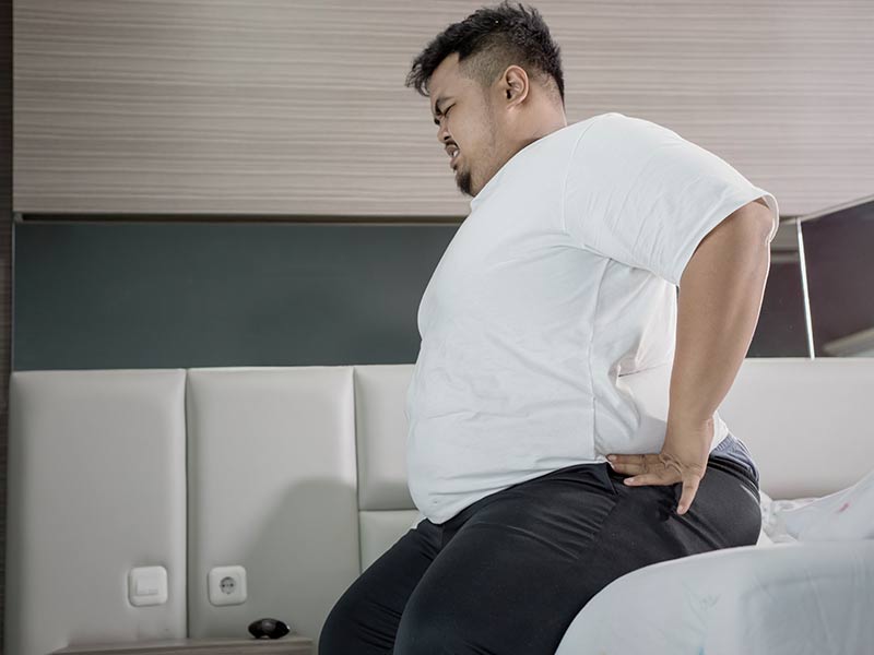 Man overweight with back pain