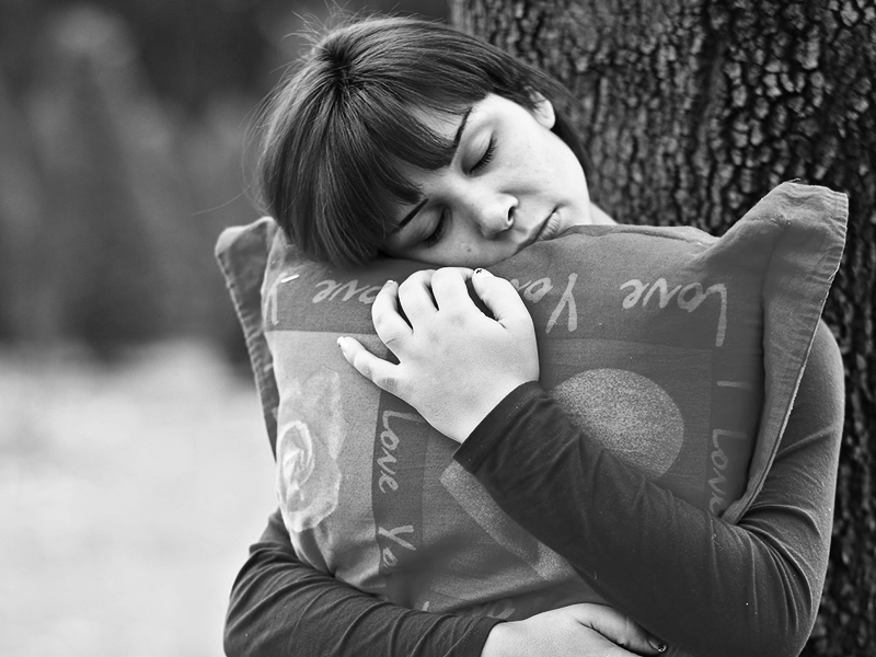 woman holding a pillow close