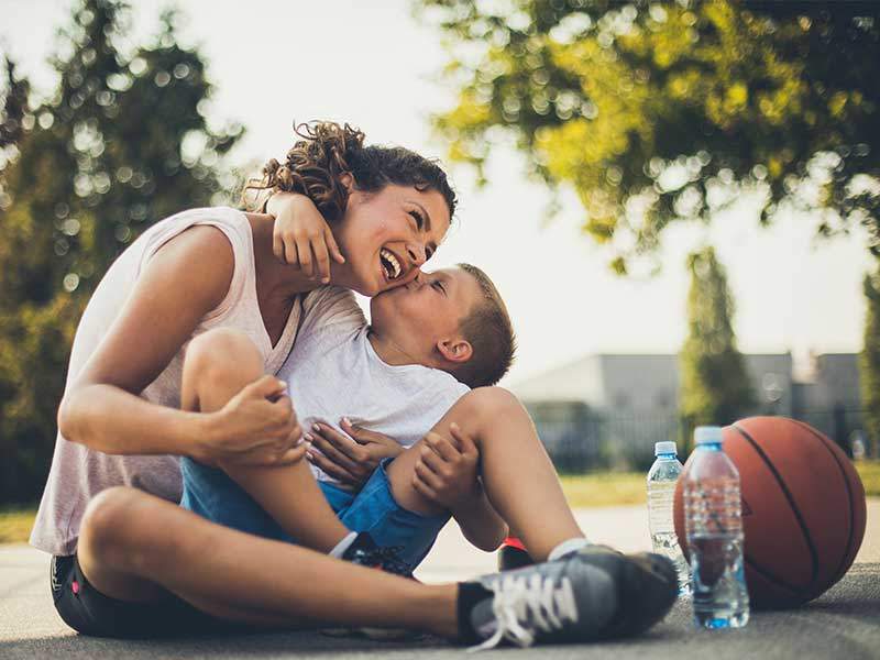 mother and child hugging on playground