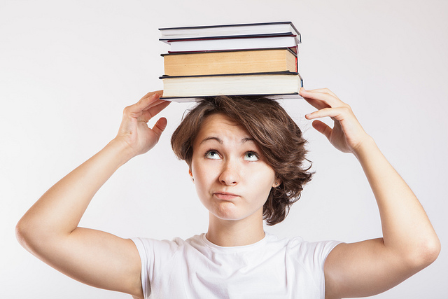 woman balancing books on her head