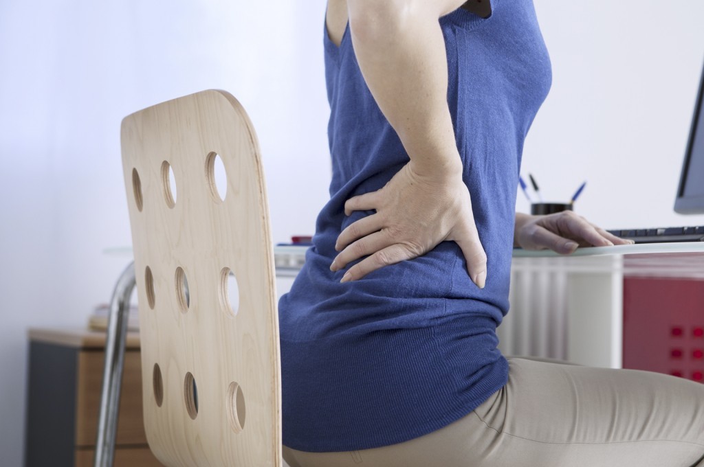 woman with lower back pain when sitting