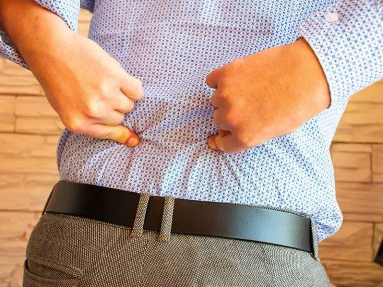 man points to lower back pain