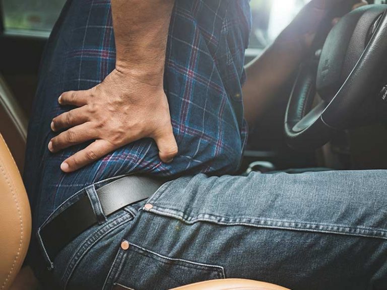 Man driving and has lower back pain