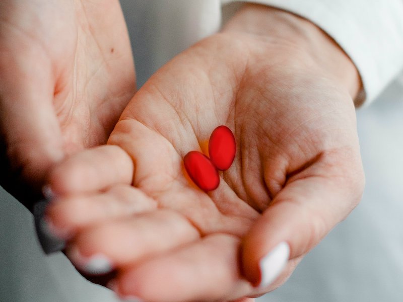 Ibuprofen in woman's hand
