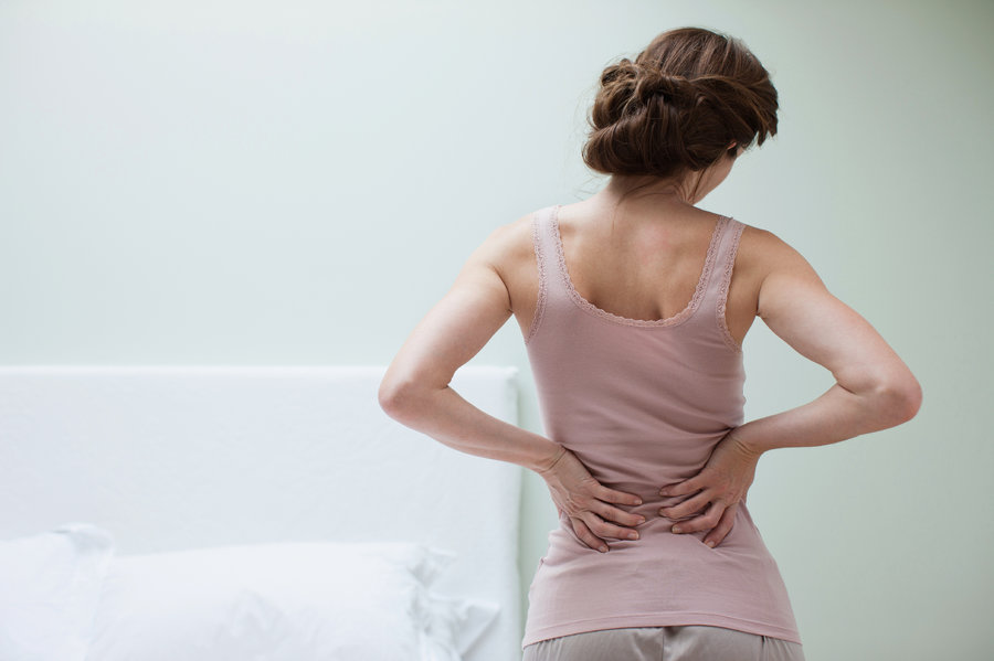 woman holding her lower back